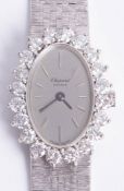 Chopard, an 18ct white gold bracelet watch. oval silver baton dial, case surrounded by 20 round
