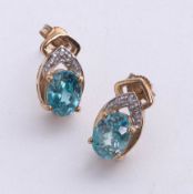 A pair 9ct diamond and topaz earrings.