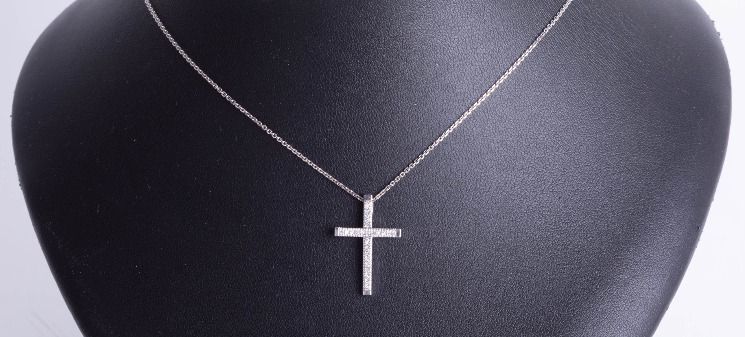 A 9ct white gold and diamond set cross, 3g, boxed.