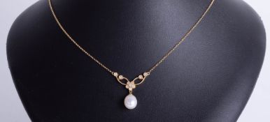 An 18ct diamond necklace, set with oval shaped freshwater pearl pendant with flower design bar set