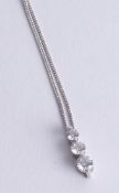 An 18ct white gold diamond three stone pendant set with graduated diamonds.