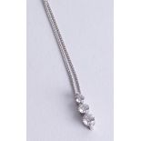 An 18ct white gold diamond three stone pendant set with graduated diamonds.