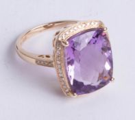 A 14k yellow gold and diamond ring set with a cushion cut purple amethyst approx 9.40carats,