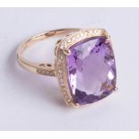 A 14k yellow gold and diamond ring set with a cushion cut purple amethyst approx 9.40carats,