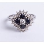An 18ct white gold sapphire and diamond 25 stone cluster ring, size M.