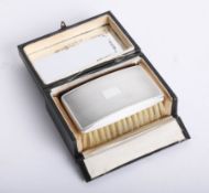 A cased small silver clothes brush.