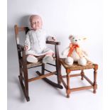 A vintage doll, a '2015' Steiff bear, a miniature rocking chair and a miniature foot stool.