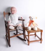 A vintage doll, a '2015' Steiff bear, a miniature rocking chair and a miniature foot stool.