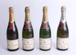 Four bottles of 1980's Moët and Chandon champagne.