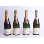 Four bottles of 1980's Moët and Chandon champagne.