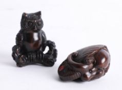 Two Japanese dark wood netsukes, one depicting an octopus in a shell and the other depicting an owl.