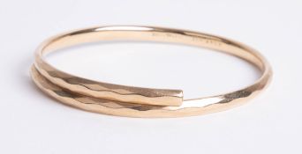 A modern gold plated bangle.