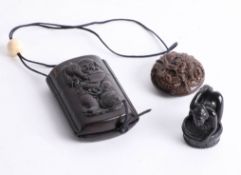 A Japanese inro depicting a man carrying a barrel and a netsuke depicting a dragon, and an erotic