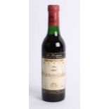 A half bottle of 1966 Mouton-Cadet red wine.