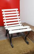 Early 20th Century garden seat with wood slats and wrought iron base.