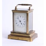 A brass carriage clock on base, maker unknown, height 15cm.