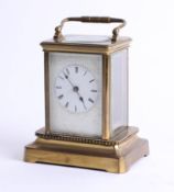 A brass carriage clock on base, maker unknown, height 15cm.