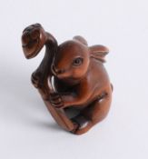 A carved wood netsuke, depicting a Hare.