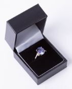 An 14k tanzanite and diamond mixed colour ring in yellow gold, size N.