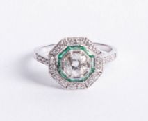 An 18ct diamond and emerald Art Deco style ring, set in white gold, size N.