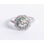 An 18ct diamond and emerald Art Deco style ring, set in white gold, size N.