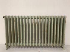 A large old cast iron radiator, previously from the old Plymouth City Museum, 77cm x 137cm.