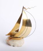 A contemporary gilt model of a sailing yacht on marble base, signed, height 25cm.