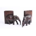 A pair of carved wooden elephant bookends.