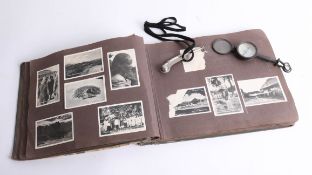 A Bosuns whistle, war time compass site and an album of snap shot photographs inscribed inside cover