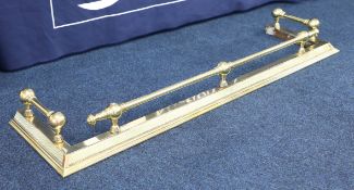 A brass fender, 121cm opening.