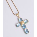 An aquamarine and yellow gold cross on a chain, 13.8g.