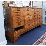 A vintage oak haberdashery cabinet fitted with 19 drawers (one missing), length 178cm, height