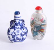 Two oriental perfume bottles, one depicting the Great Wall of China and the other depicting