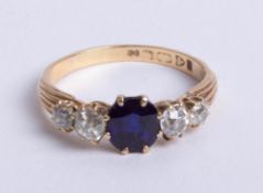 An 18ct diamond and sapphire ring, size P.