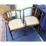 A pair of Edwardian inlaid corner chairs.