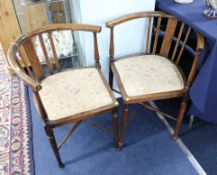 A pair of Edwardian inlaid corner chairs.