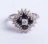 An 18ct white gold sapphire and diamond 25 stone cluster ring, size M.