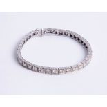 An 18k gold and diamond set bracelet, set with approx. 4 carats of diamond, assed colour J-K and