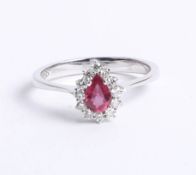 An 18k diamond and ruby ring with box and certificate, size N.