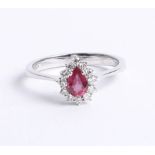 An 18k diamond and ruby ring with box and certificate, size N.