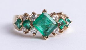 A 14k emerald and diamond set abstract design ring, with insurance appraisal indicating clarity S1