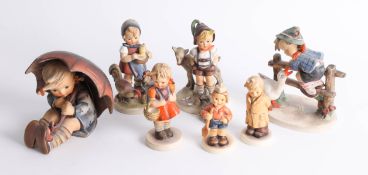 Seven Hummel figures including a large 'Umbrella Girl' group, height 13cm.