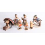 Seven Hummel figures including a large 'Umbrella Girl' group, height 13cm.