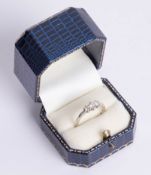An 18ct white gold and three stone diamond ring, total weight approx. 0.50carat, size P.