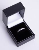 An 18ct white gold and diamond band ring, size M.