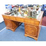 A leather topped two pedestal desk fitted with nine drawers, height 76cm and width 150cm, also