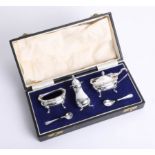 A Geo V silver condiment set, cased.