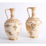 Royal Crown Derby porcelain, pair of handled vases of blush ivory design embellished with gilt work,