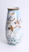 A pair of signed Japanese earthenware ware vases decorated flying geese and flowers, height 31cm.