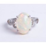 An 14ct opal and diamond ring, size N.